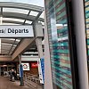 Departures and arrivals boards lit up red with delayed flights at Kelowna airport