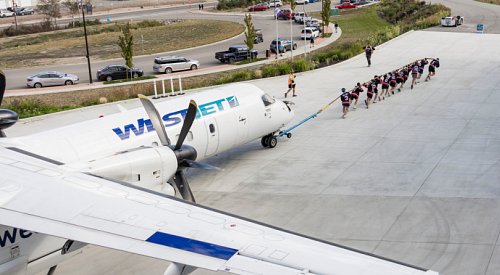 How do 12 people pull a 67,000-pound airplane 100 metres?